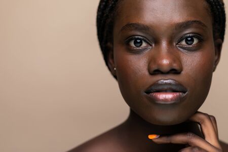 Young african girl with perfect skin on white background.