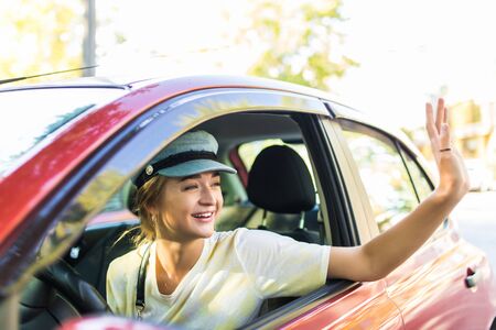 Caucasian car driver woman greetsの写真素材