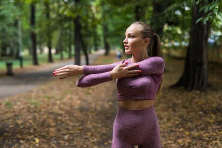 Stretching athlete warming up for a workout outdoors. healthy fitness lifestyle