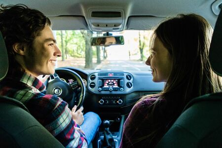 Portrait of an couple driving a car and about to go on a trip