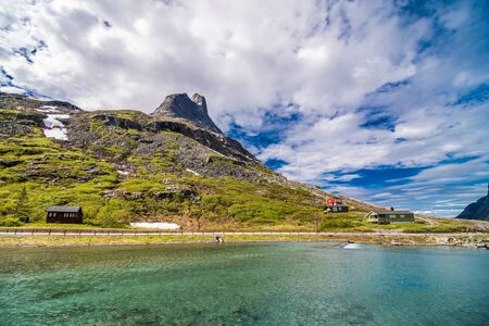 Trollstigen, Norway - June, 2019: Famous norwegian mountains road Trollstigen top view of valley. Epic nordic nature with rocks, waterfalls, dramatic clouds Sightseeing tourism, travel europeの写真素材