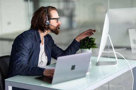 Customer service representative wearing a headset at the office