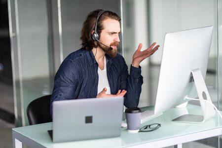 Call center operator working at his desk