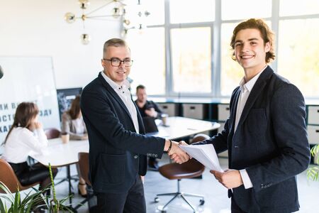 Two colleagues handshaking after meeting