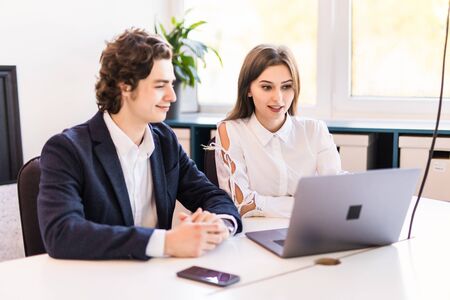 Couple discussing new project on the laptop. Teamwork concepts.