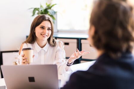 Young couple pointing to a laptop display. Business conceptの写真素材