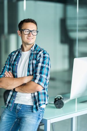 Smiling happy confident businessman looking at the camera with a warm beaming smile, close up head...