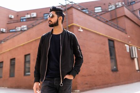 Handsome indian man in sunglasses outdoor at streets of city.の写真素材