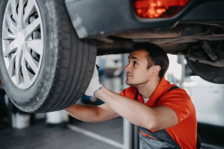 mechanic changing a car wheel.の写真素材