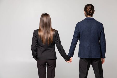 Back view business team beautiful woman and man in suit together over white background.の写真素材