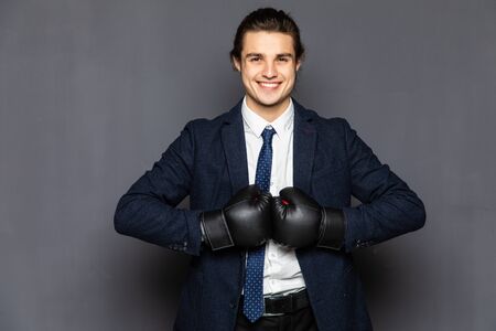 business man with boxing gloves isolated in whiteの写真素材