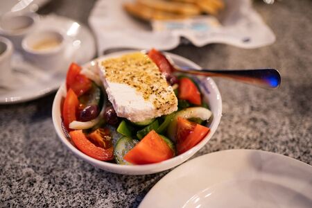 Salad on plate with sauce in restaurantの写真素材