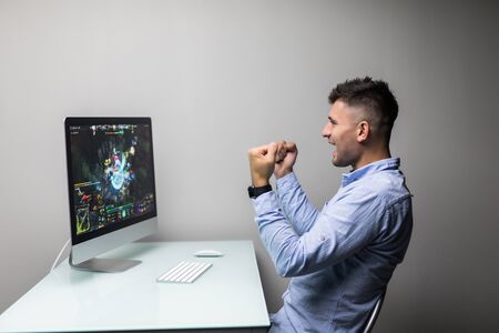 Cheerful delighted man winning the computer gameの写真素材