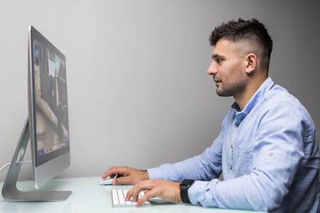 Happy Man With Headset Playing Game On Desktop Computer At Homeの写真素材