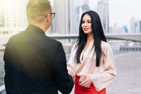business people shaking hands with city backgroundの写真素材