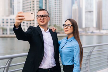 Young working colleagues photographing themselvesの写真素材