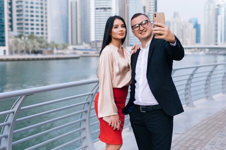 Young working colleagues photographing themselves