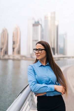 Portrait of a successful business woman smiling. Beautiful young female executive in an urban settingの写真素材