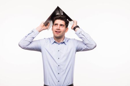 Portrait of a cheerful man holding laptop over head on white background