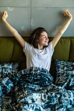 Young beautiful, woman waking up fully rested.