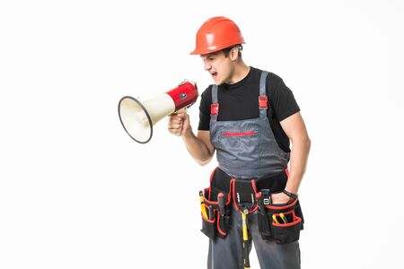 Full length of worker speaking into megaphone over white backgroundの写真素材