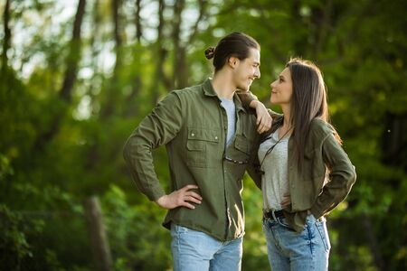 Happy young couple hugging and laughing outdoors.