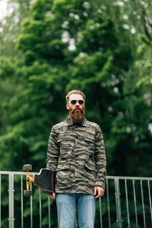 Portrait of bearded man smiling at camera in extreme parkの写真素材