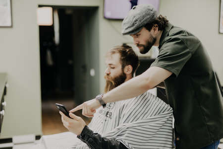 Haircut men Barbershop. Men's Hairdresser barbers. Barber cuts the client machine for haircuts.の写真素材
