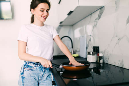 Young pretty woman cooking in the kitchen. Healthy Food. Dieting Concept. Healthy Lifestyle. Cooking At Home.の写真素材