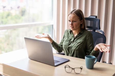 young business woman in a hopeless situation on her laptop