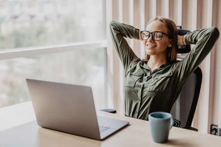 Portrait of relaxed business woman in officeの写真素材