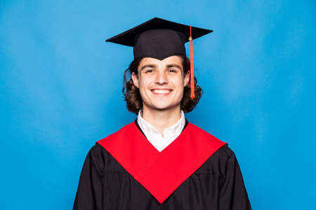 Graduate Man Holding Degree Isolated On Blue Backgroundの写真素材