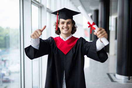 Graduate male student - graduation concepts. Portrait on his graduation day. University.の写真素材