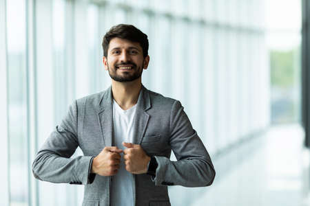 Businessman posing confident and positive in professional workplace office with spaceの写真素材
