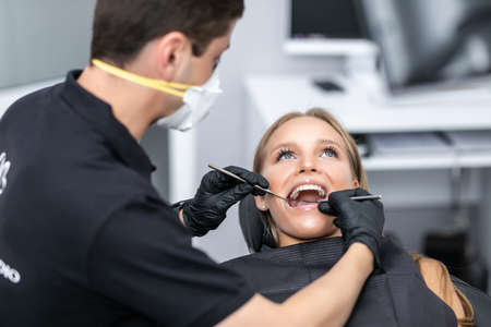 beautiful woman visiting dentist for dental checkup