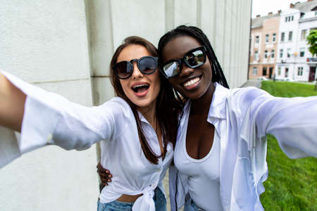 Selfie time. Happy girls taking a Selfieの写真素材