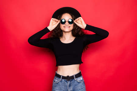 Young woman isolated over red backgroundの写真素材