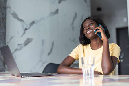 Beautiful young African American talking on her mobile listening to a callの写真素材