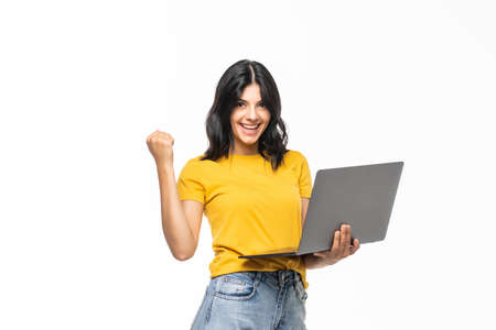 casual success girl on a laptop isolated over a white backgroundの写真素材