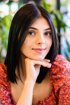Portrait of confident woman smiling in cafe