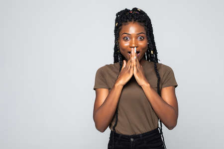 Young african woman with surprised emotions on gray background