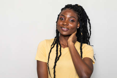 Young african woman standing on white background