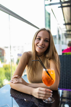 Woman with cocktail in street cafeの写真素材