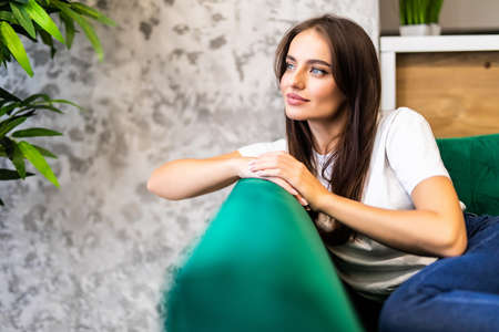 Attractive woman relaxing in sofa at homeの写真素材