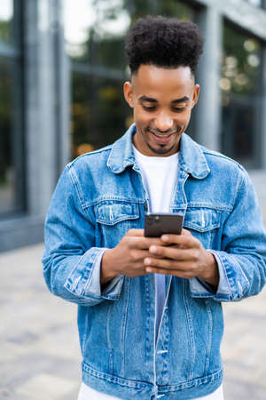 Handsome african man use phone on the city street