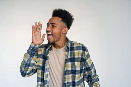 Young african man scream on white background