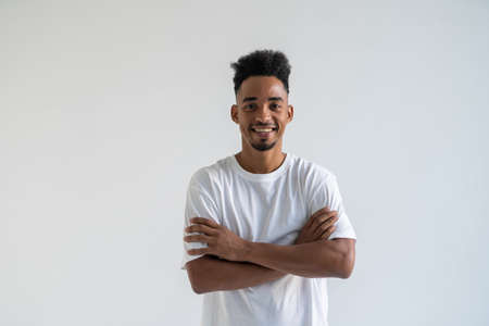 Image of handsome young african man standing isolated over white background. Looking camera.