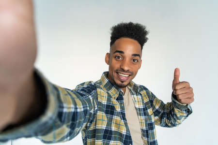 Young african man take selfie isolated on white background