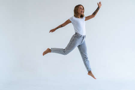 Young woman jumping in the air happily