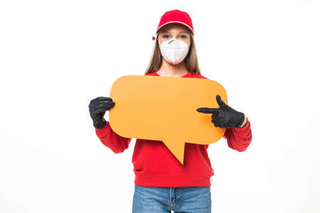 Delivery employee woman in red cap blank t-shirt uniform protect face mask gloves work courier service during quarantine coronavirus covid-19 virus hold speech bubble isolated on white backgroundの写真素材